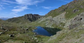 La conca del Lago Superiore di Lusia. Sullo sfondo, la Cresta delle Mandre e Cima di Laste’